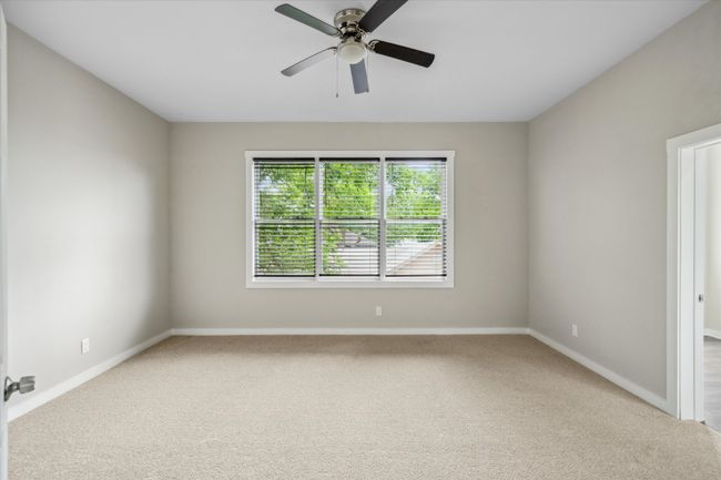 Empty room with carpet floors, baseboards, and a ceiling fan | Image 29