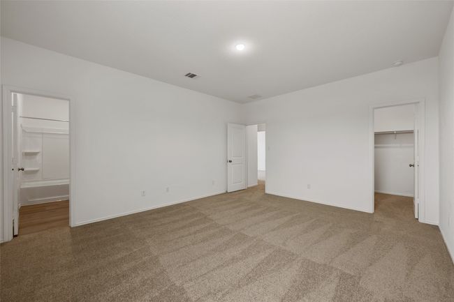 Unfurnished bedroom with a spacious closet, carpet flooring, and connected bathroom | Image 24