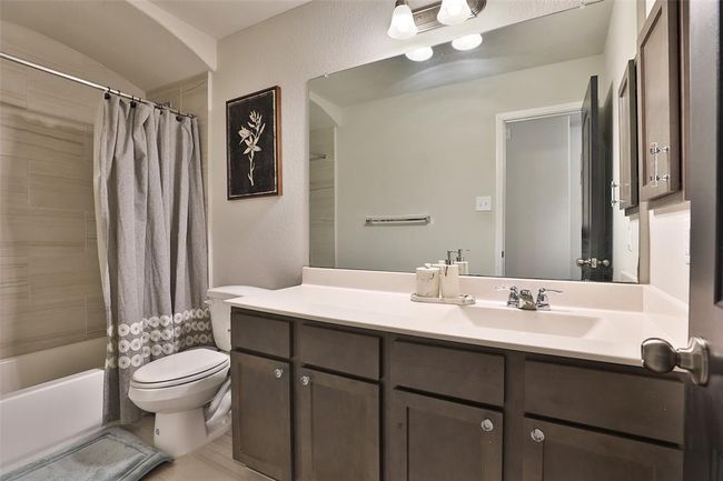 An upstairs full bathroom featuring ample counter space for added convenience. | Image 24