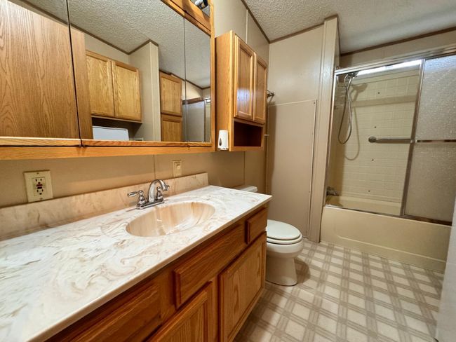 Full bathroom with an oversized vanity and lots of storage space | Image 10