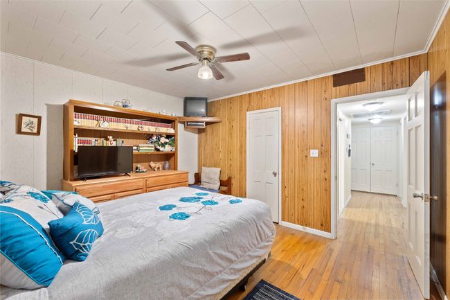 Good size bedroom off the kitchen area with beautiful wooden floors and entrance to hallway and guest bathroom. | Image 21