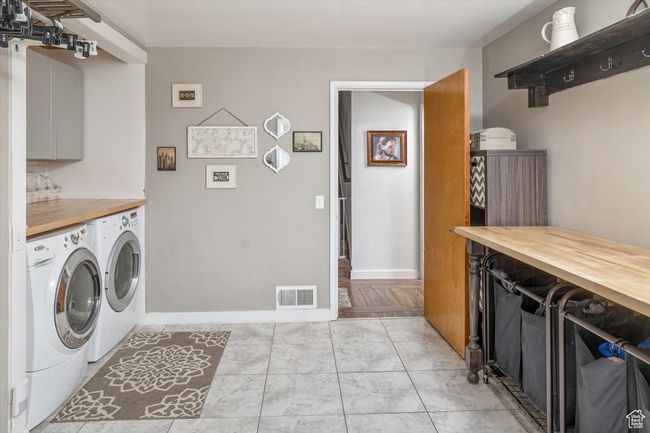 Washroom featuring washer and clothes dryer and cabinets | Image 21