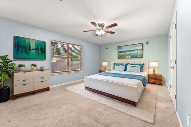Photo virtually staged. Bedroom with carpet floors, baseboards, and ceiling fan | Image 17
