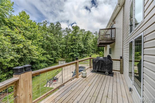 Deck featuring grilling area, an outbuilding, and a lawn | Image 62