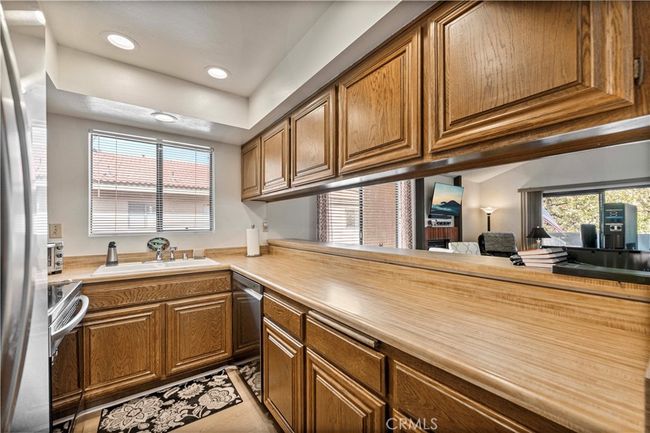 Super clean kitchen with recessed lighting opens to living room. | Image 11
