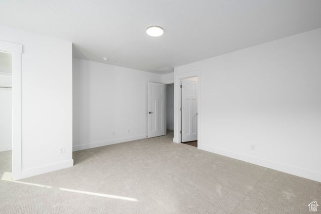 Unfurnished bedroom with a closet, baseboards, a spacious closet, and carpet flooring | Image 12