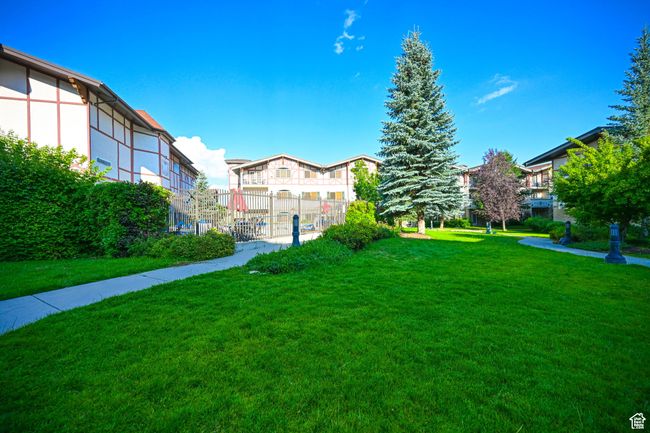 View of home's community with a yard, fence, and a residential view | Image 6