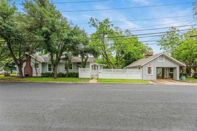Side of home with arched fencing | Image 32