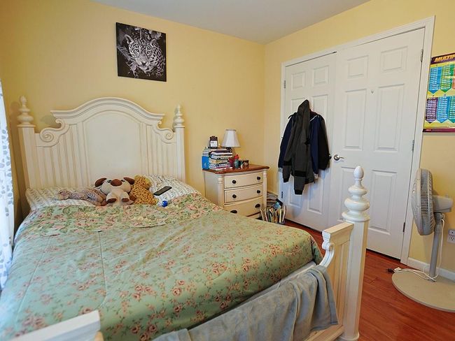 Bedroom with a closet and wood finished floors | Image 28