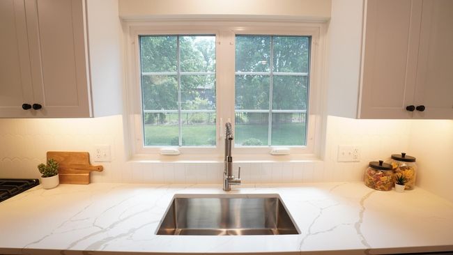 The windows over the large kitchen sink overlook the spacious, flat backyard of this oversized property. | Image 39