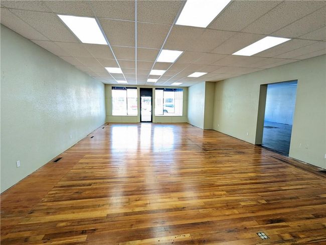 Spare room featuring a paneled ceiling and hardwood / wood-style flooring | Image 15