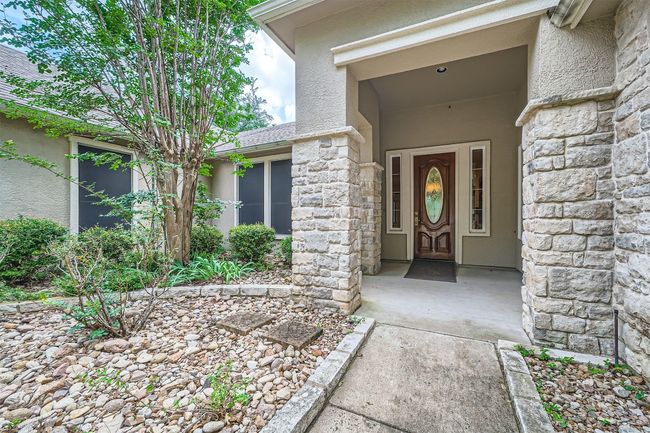 Property entrance with stone siding and stucco siding | Image 5