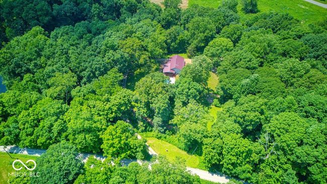 aerial view of property and surrounding area featuring a heavily wooded area | Image 10