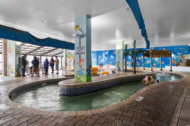 Indoor pool with an indoor hot tub | Image 26