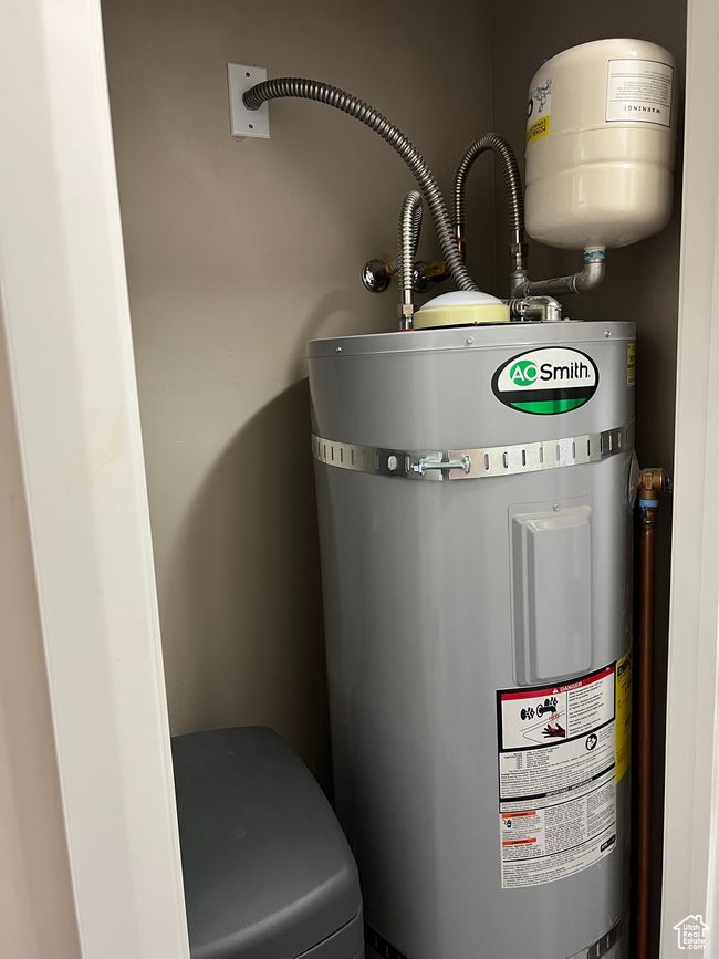 Utilities featuring strapped water heater | Image 58