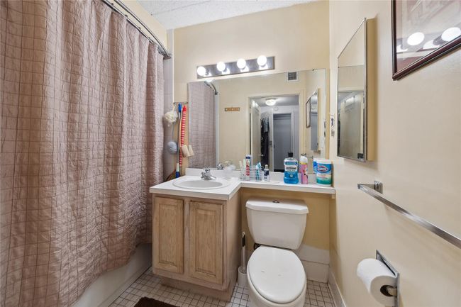Bathroom featuring tile patterned floors, vanity, and shower / tub combo | Image 18