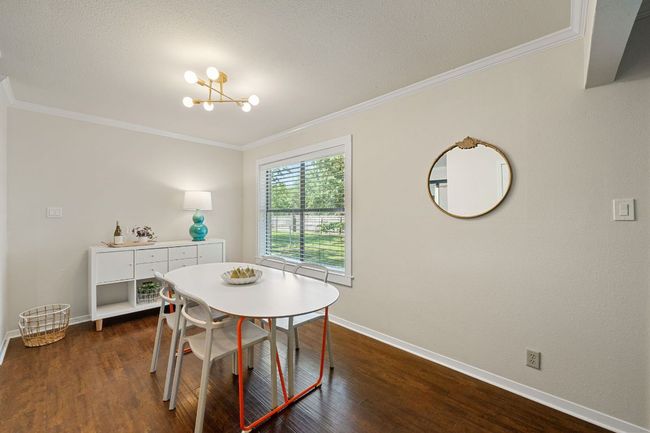Eat-in kitchen features freshly painted dining room and updated light fixture. | Image 8