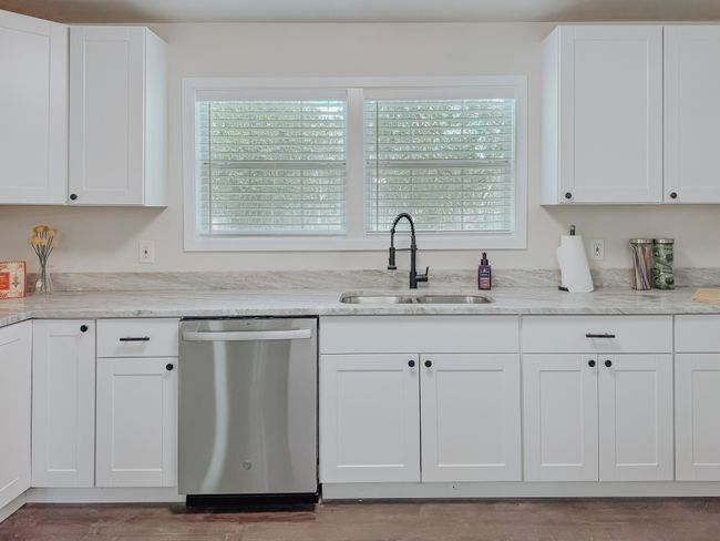 Kitchen featuring dishwasher, plenty of natural light, and white cabinets | Image 15