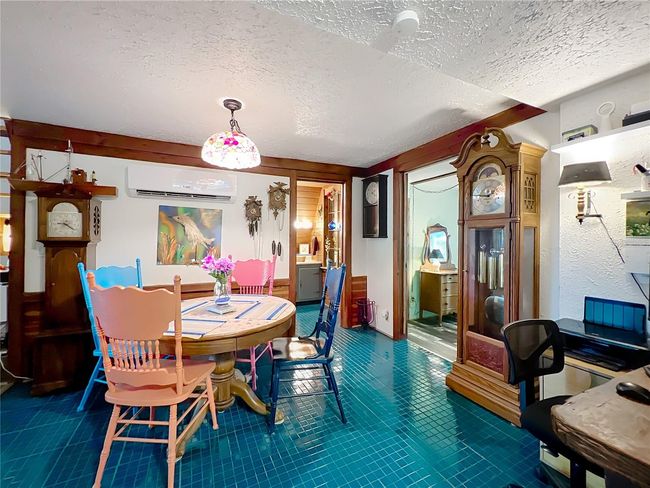 From kitchen of dining, 1st doorway is primary bath (center) and 2nd doorway is Primary Bedroom. You can also see the built in office nook at the lower right | Image 23