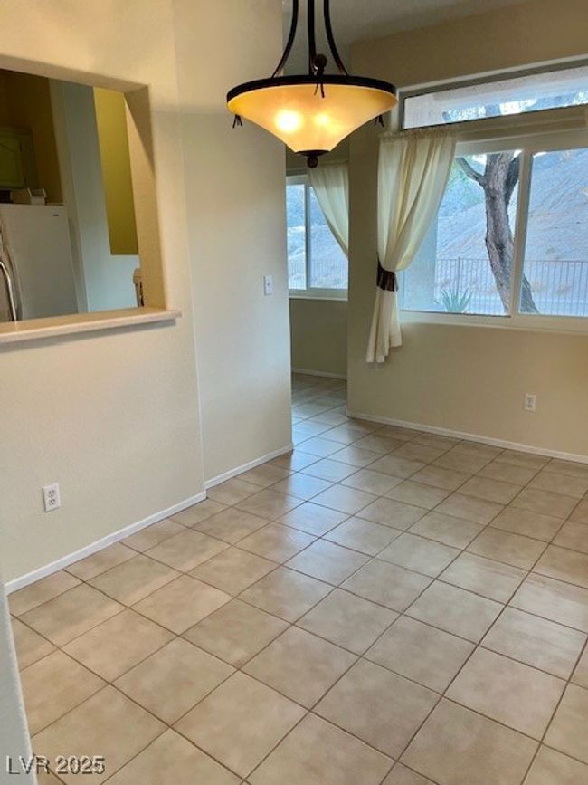 Unfurnished dining area featuring baseboards and light tile patterned floors | Image 9