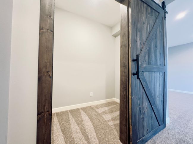 Sleek barn door hides a large storage closet in the lower level. | Image 18