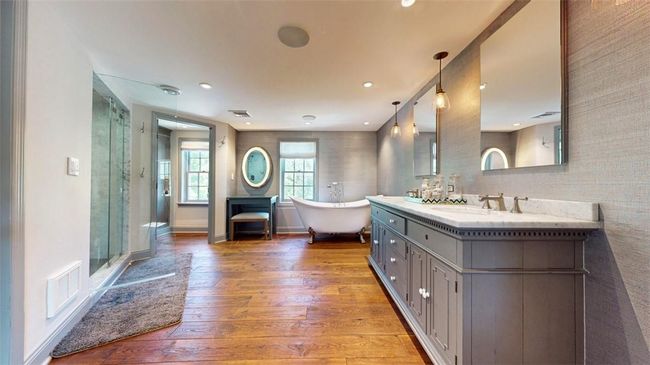 Bathroom with hardwood / wood-style flooring, independent shower and bath, and vanity with extensive cabinet space | Image 23