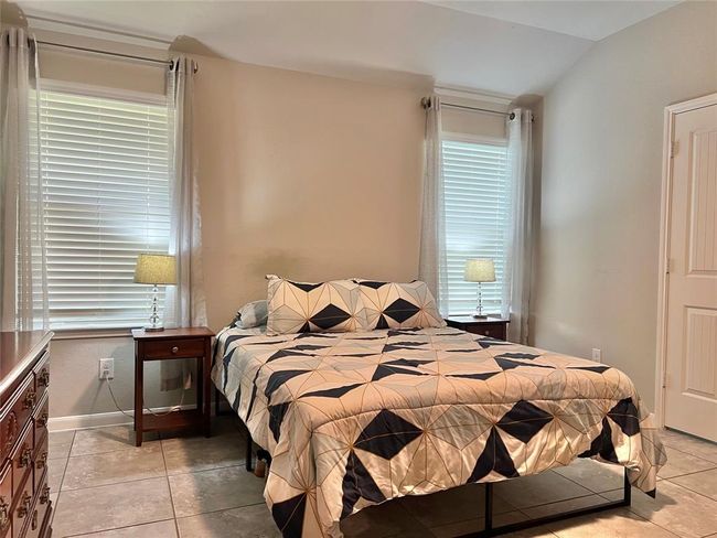 Expansive primary bedroom with abundant natural light. | Image 12