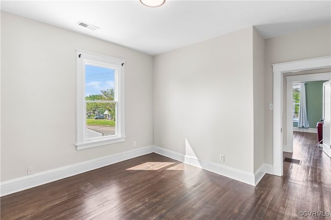 Spare room with baseboards, wood finished floors, and visible vents | Image 28