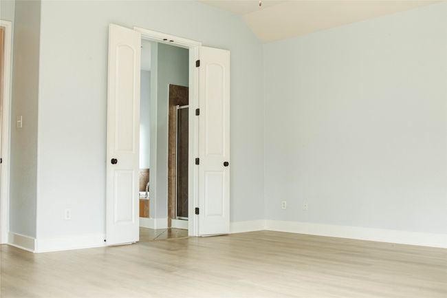 Empty room featuring light wood finished floors and vaulted ceiling | Image 26