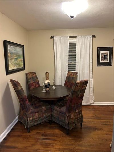 Dining room with dark wood-type flooring | Image 3