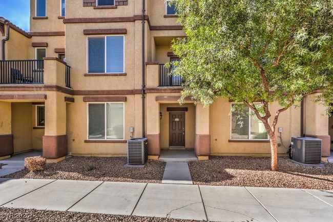 View of front facade with central AC and stucco siding | Image 9