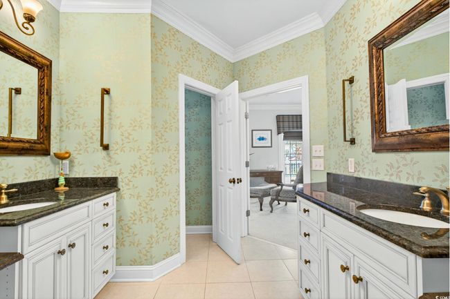 Full bathroom with ornamental molding, two vanities, and tile patterned flooring | Image 26