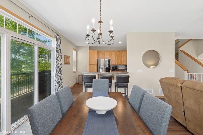 The dining room is perfectly positioned between the kitchen and deck, making gatherings and everyday meals a breeze | Image 15