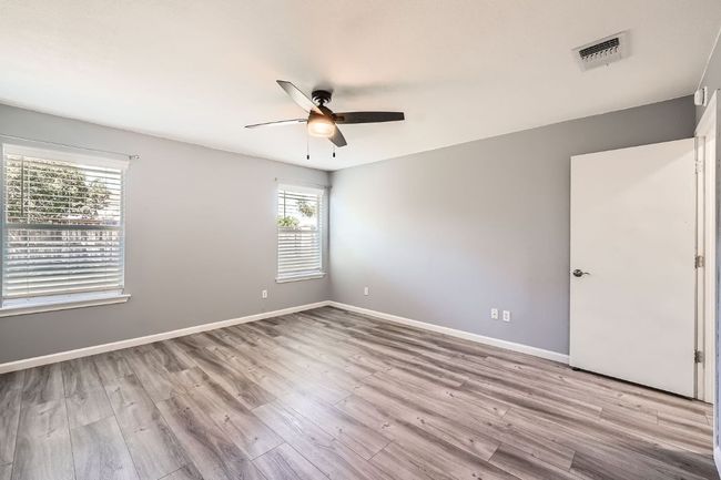 Spare room featuring baseboards, visible vents, light wood-style flooring, and a ceiling fan | Image 13