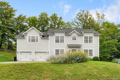 View of front of home featuring a garage and a front lawn | Image 1