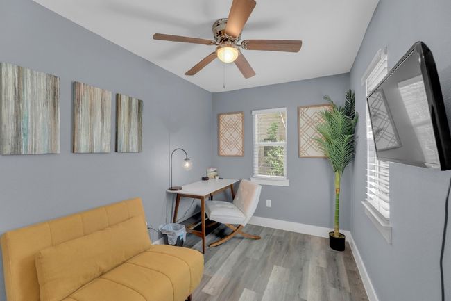 Living area featuring a ceiling fan, baseboards, and wood finished floors | Image 21