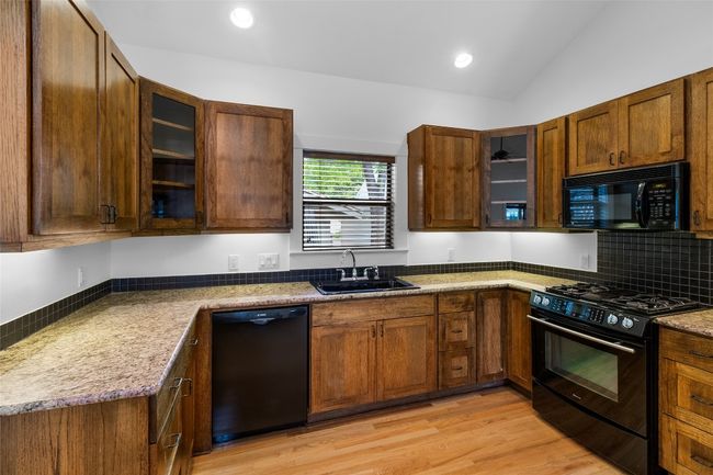 Kitchen with glass insert cabinets | Image 11