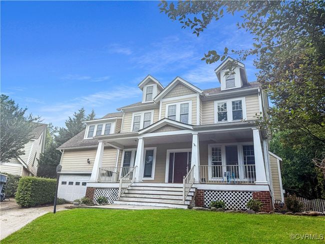 View of front of home featuring covered porch, concrete driveway, an attached garage, and a front lawn | Image 25