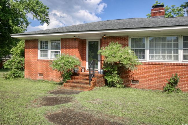 View of front of house featuring crawl space, brick siding, and a front lawn | Image 5