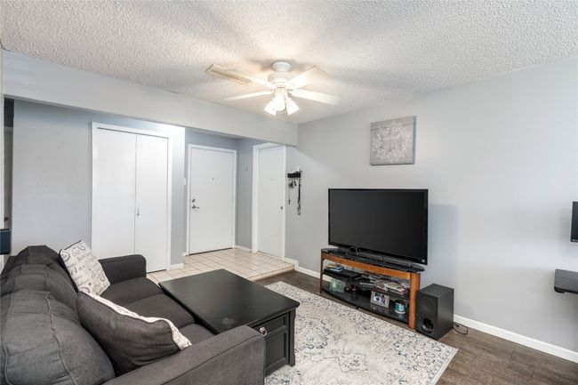 Living room featuring hardwood / wood-style flooring and ceiling fan | Image 6