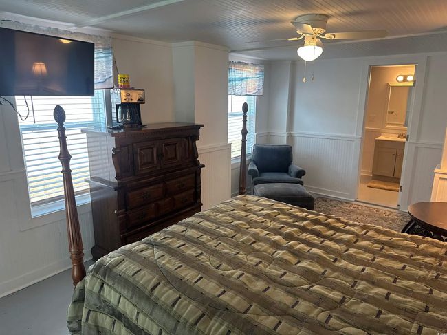 Bedroom with a wainscoted wall and ensuite bath | Image 19