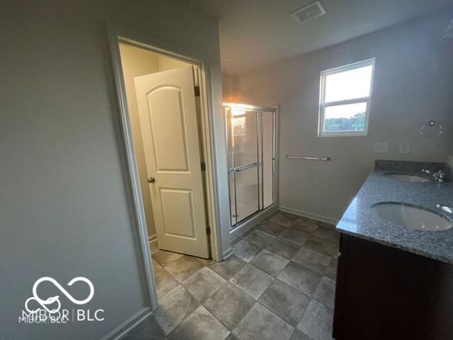 full bath with a sink, visible vents, baseboards, and a shower stall | Image 14