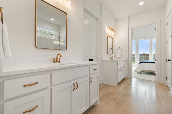 Primary bathroom has seperate vanities and gold fixtures | Image 15