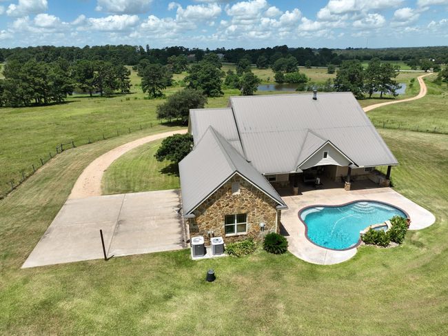 Discover your private oasis with this aerial view of a home featuring a sparkling pool. | Image 4
