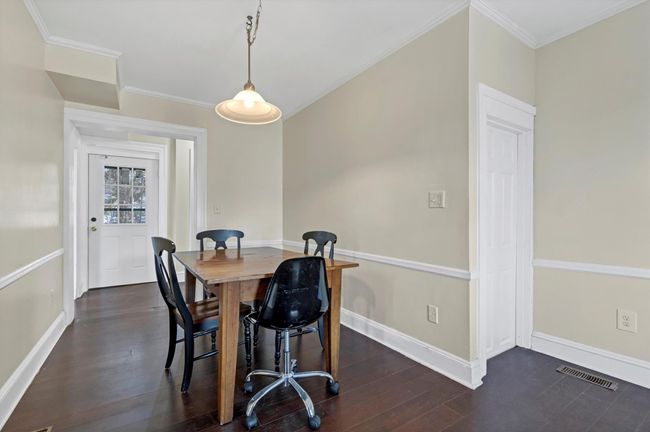 Dining area featuring baseboards, ornamental molding, and dark wood-type flooring | Image 8