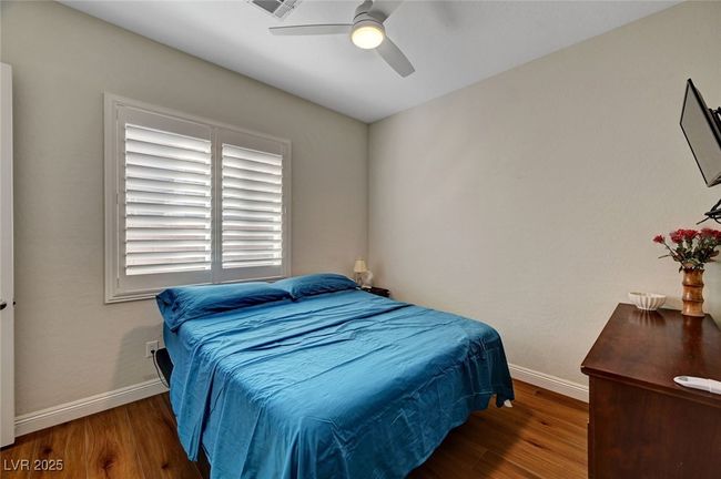 Bedroom featuring wood finished floors and ceiling fan | Image 39