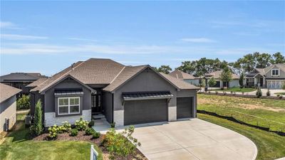 View of front of home with a garage, central AC, and a front yard | Image 1