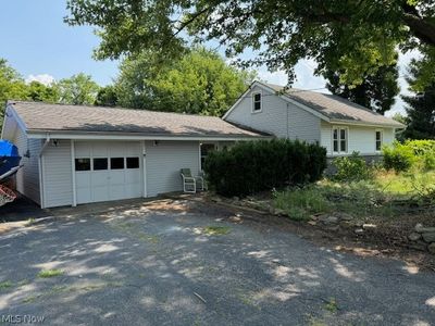 View of side of home with a garage | Image 1