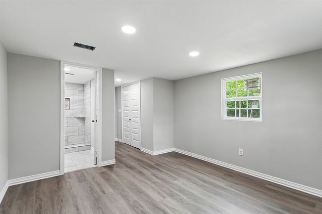 Primary bedroom with vinyl floors, recessed lighting, and connected bathroom | Image 6