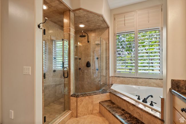 Master Bathroom featuring healthy amount of natural light, a bath, a stall shower, and tile patterned flooring | Image 41